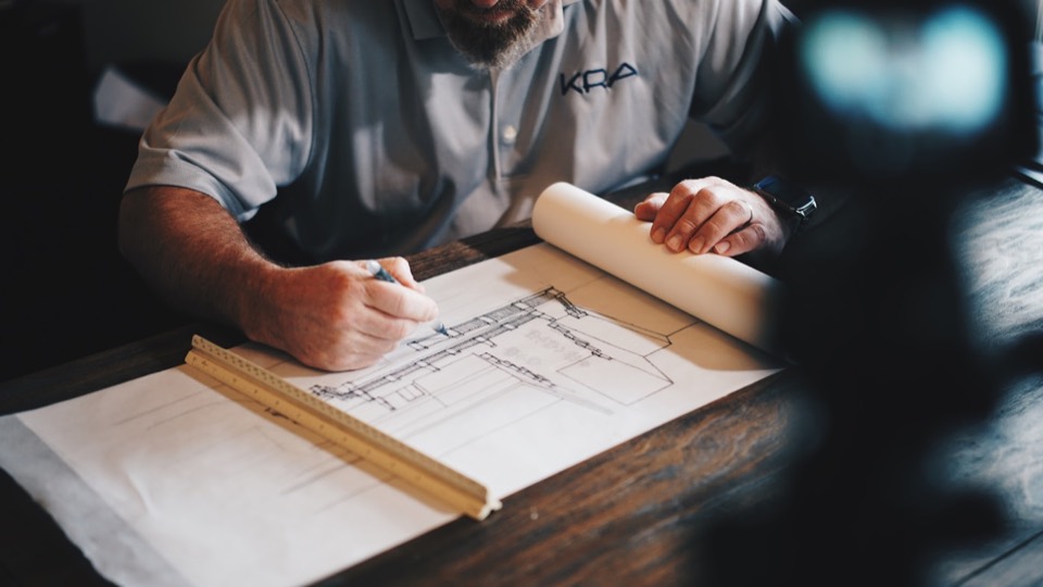 Service business owner reviewing plans and customer work details
