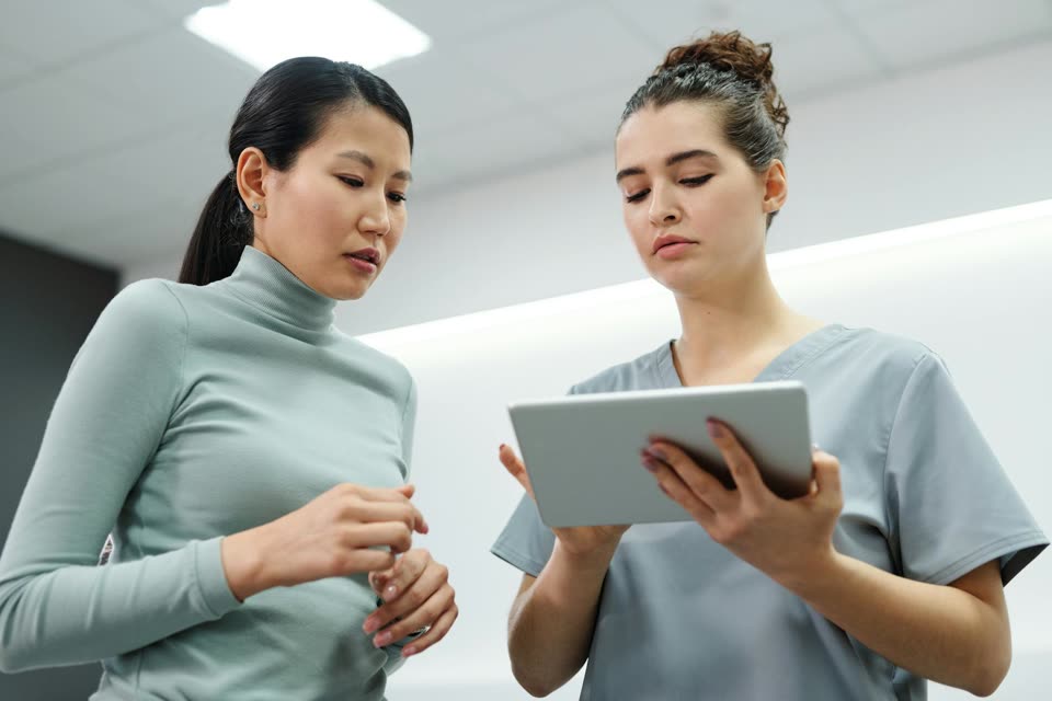 Doctor and patient reviewing care information on a tablet